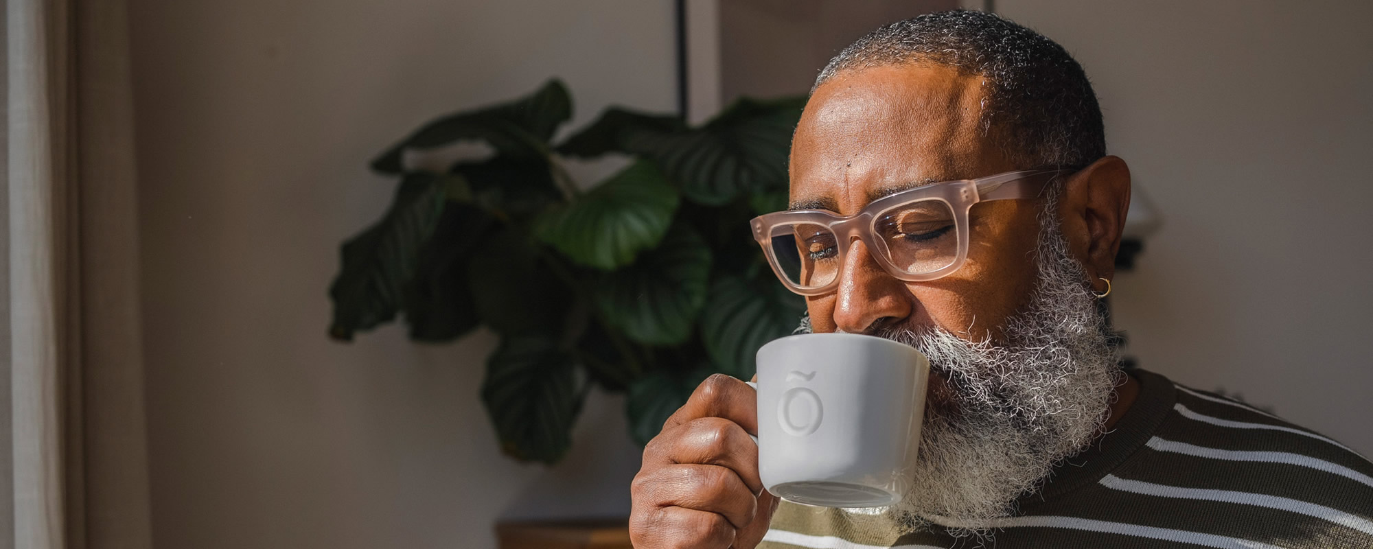 Man enjoying cold milk thickened with Slõ Syrup. Drinks thickener dysphagia friendly.