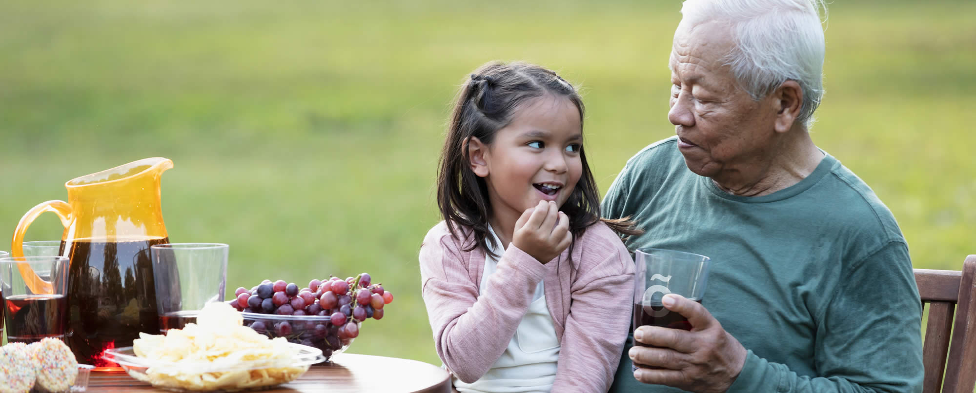 grandfather sat with grandchild enjoying Fizzy drink thickened with Slõ Syrup.